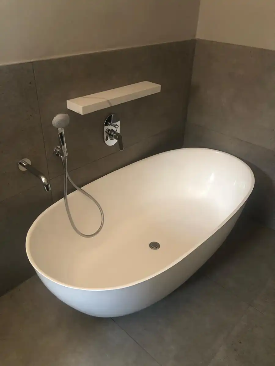 Bathroom renovation with freestanding bath and contemporary grey tiling