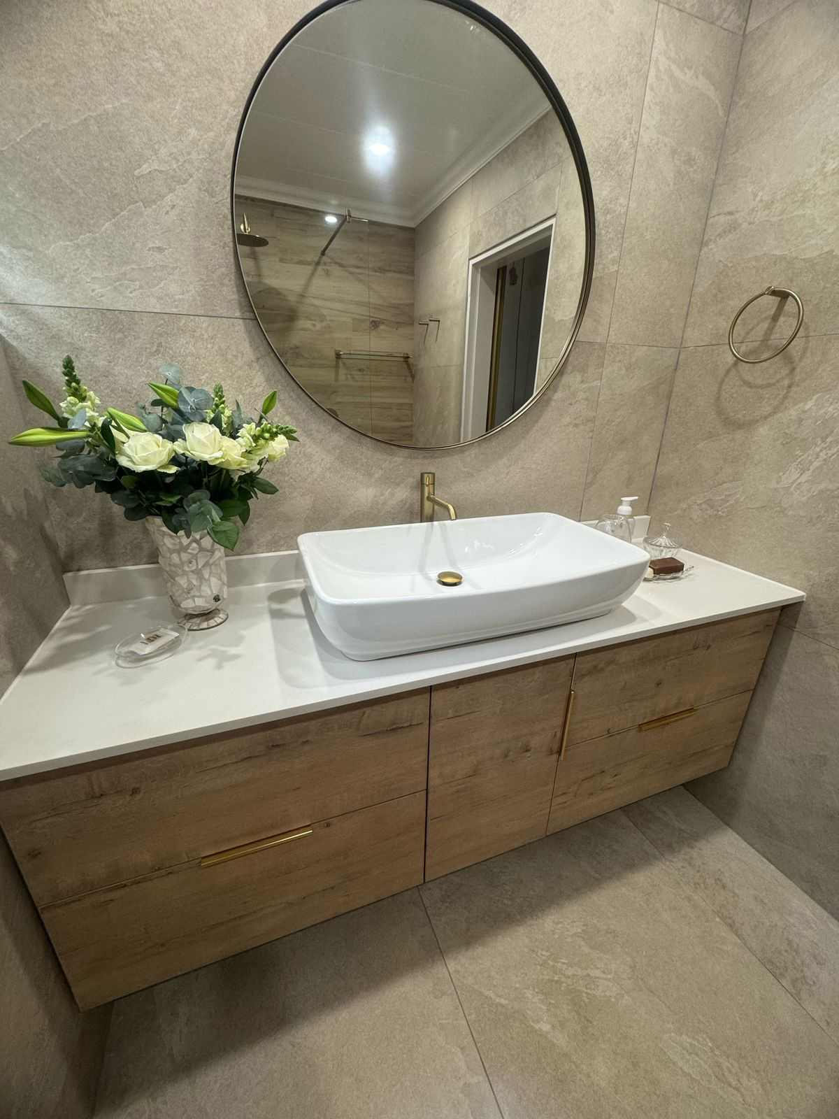Bathroom renovation with modern shower and brass finishes